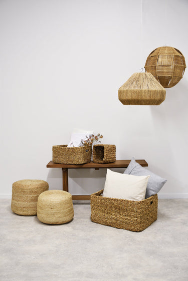 Round braided jute pouf natural styled in a living room