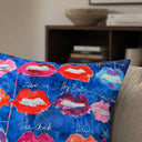 Lips on blue velvet cushion styled on a sofa