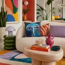 Brushwork detail on the teal abstract face cushion
