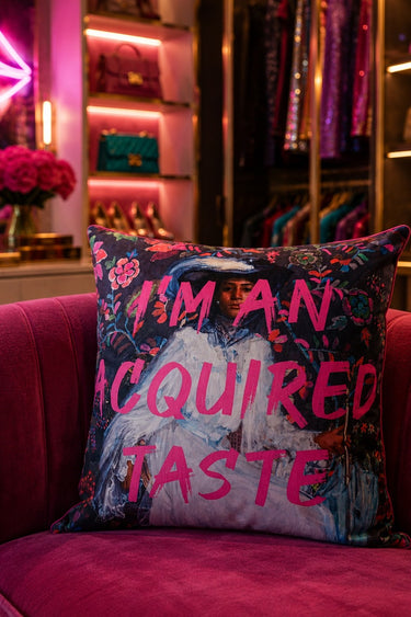 Acquired Taste slogan velvet cushion styled on a sofa
