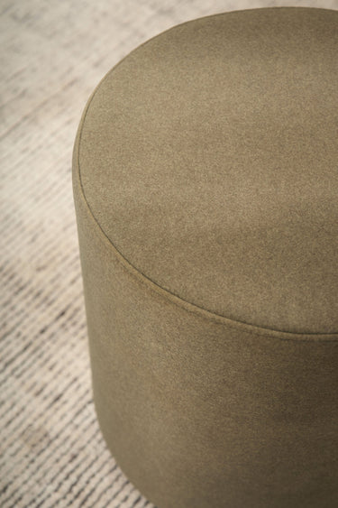 Mee Swivel Ottoman in a living room