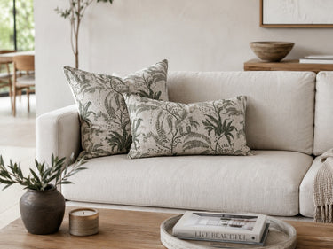 Green floral herringbone cushion styled on a sofa