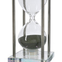 Close up of the green sand inside the blown glass hourglass