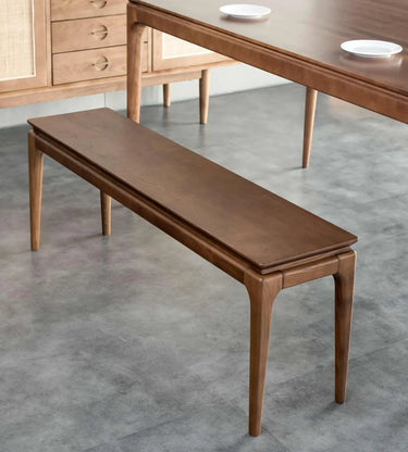 Baur Bench Seat angled view showing the tapered solid ash legs