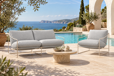 Coco Sling outdoor lounge set in Fossil by a pool with sea views
