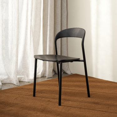Black Olly dining chair in a dining room with timber floor