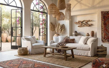 Modern living room featuring a cream fabric sofa, woven pendant lights, and a rustic wooden coffee table - 2026 furniture trends NZ.