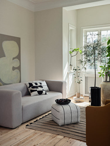 Broste Sigrid Pouf light beige black styled in a living room