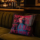 Bad Example slogan velvet cushion styled on a sofa