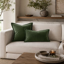 Green velvet cushion styled on a sofa
