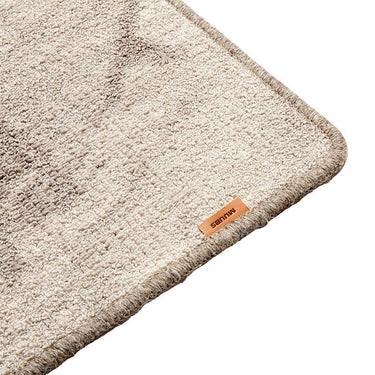 Close-up of the MUUBS Surface rug's grey and sand pattern