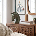 Mottled green and umber patina texture on the horse head sculpture