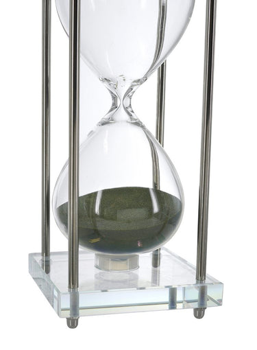 Close up of the green sand inside the large blown glass hourglass