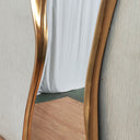 Vintage gold abstract mirror styled in a room