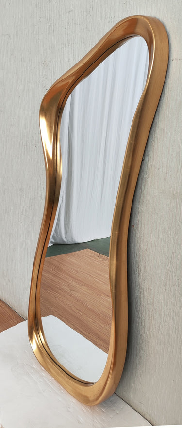 Vintage gold abstract mirror styled in a room