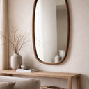 Walnut oval mirror styled in a room