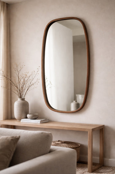 Walnut oval mirror styled in a room