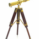 Handcrafted wooden tripod stand supporting the golden brass nautical spyglass telescope
