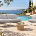 Coco Sling outdoor lounge set in Fossil by a pool with sea views