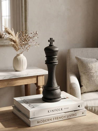 Sleek black sculptural king chess piece, a decorative accent for a bookshelf or desk