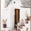 Thyra canvas wall art of a whitewashed Mediterranean doorway with cacti and terracotta pots, oak frame