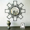 Interstellar wall mirror with round centre and radiating black metal starburst frame