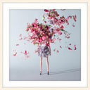 Metamorphosis framed wall art of a figure dissolving into pink blossom, white mat and white frame