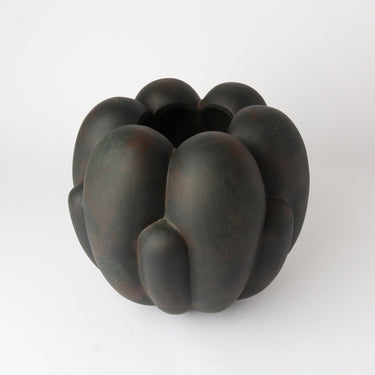 Tino Ceramic Vessel in black styled with a fresh arrangement